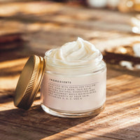 a jar of Brume d'Avril vanilla whisper tallow balm, the lid open, show the luxurious texture
