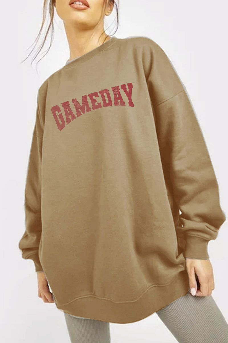 Oversized brown sweatshirt with GAMEDAY in red block letters, no pockets
