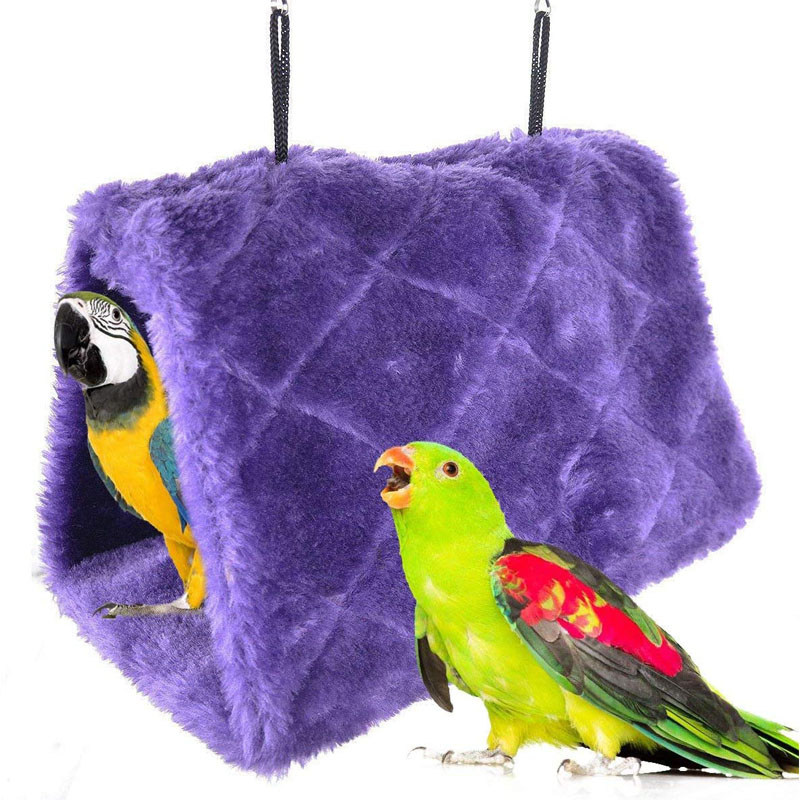 Fuzzy purple fabric bird house for parrots and parakeets. Hangers attached above and it has a triangular shape