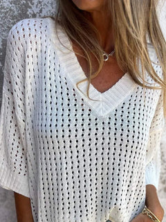 White crochet top worn by a person with a neutral background