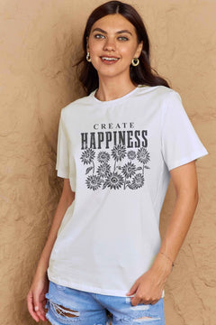 White Tshirt with round neck and short sleeves, the caption in capital letters says CREATE HAPPINESS, with create being in small letters centered over Happiness. underneath the letters, in white as well, ten flowers arranged in three rows.