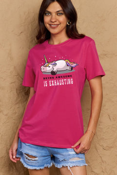 Dark Pink Tshirt with a unicorn laying on it's belly with all legs splayed out and the slogan BEING AWESOME IS EXHAUSTING under it. Round neck and short sleeves