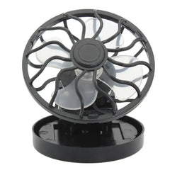Black portable fan with transparent cage on a white background has clip to mount