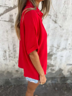 Person wearing a red shirt with a blurred background