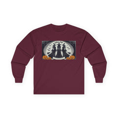 Maroon Tee shirt with a Halloween-themed graphic,witches standing with brooms facing the full moon slogan says Lets get Wicked at the bottom and Girls Trip at top