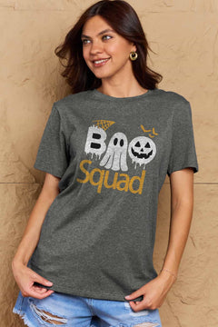 Gray round neck tshirt with short sleeves. Hallowee Theme with the word Boo but the first o is a sheet ghost and the second o is a white jack o'lantern and below that is the word Squad in orange. Above the B is an orange spider web and above the pumpkin are three orange flying bat silhouttes