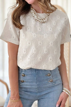Eyelet Round Neck Short Sleeve Blouse with eyelets forming diamond patterns and each corner of the diamond has a flower, all in white with a modest neckline