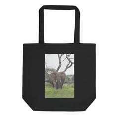 Black tote bag with an elephant in a natural setting printed on the front