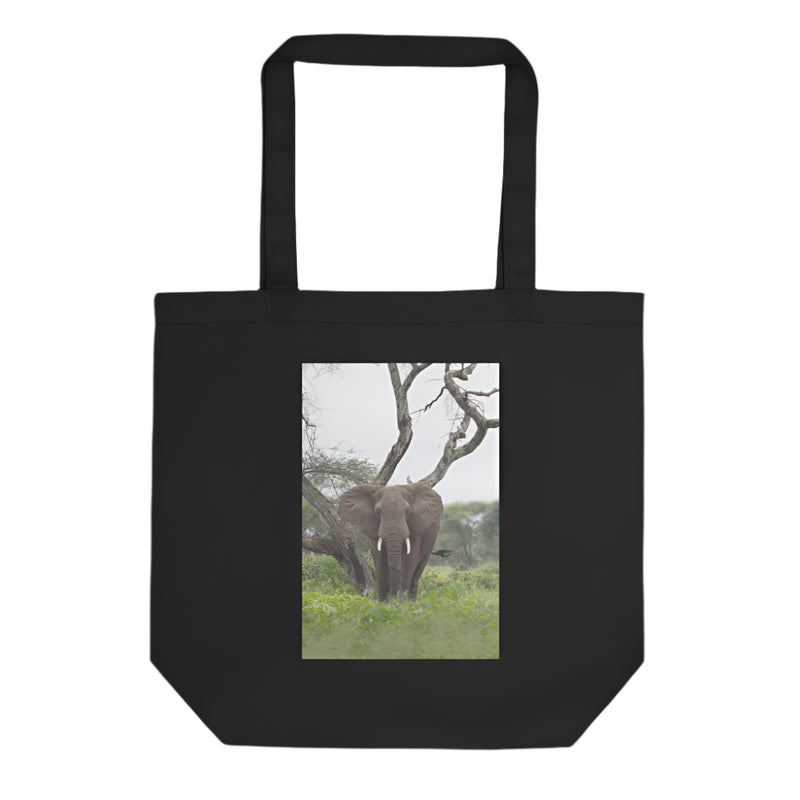 Black tote bag with an elephant in a natural setting printed on the front