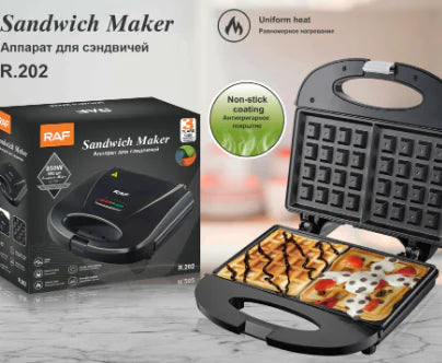 Sandwich maker with open lid showing a pizza, next to its packaging on a light background.