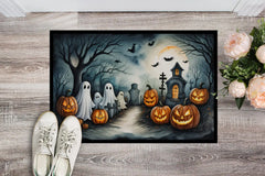 Halloween-themed doormat with pumpkins, ghosts, and a haunted house on a wooden floor.