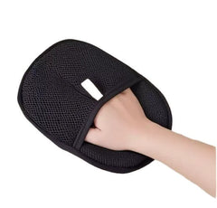 Black mesh grooming glove with a hand inserted, white background