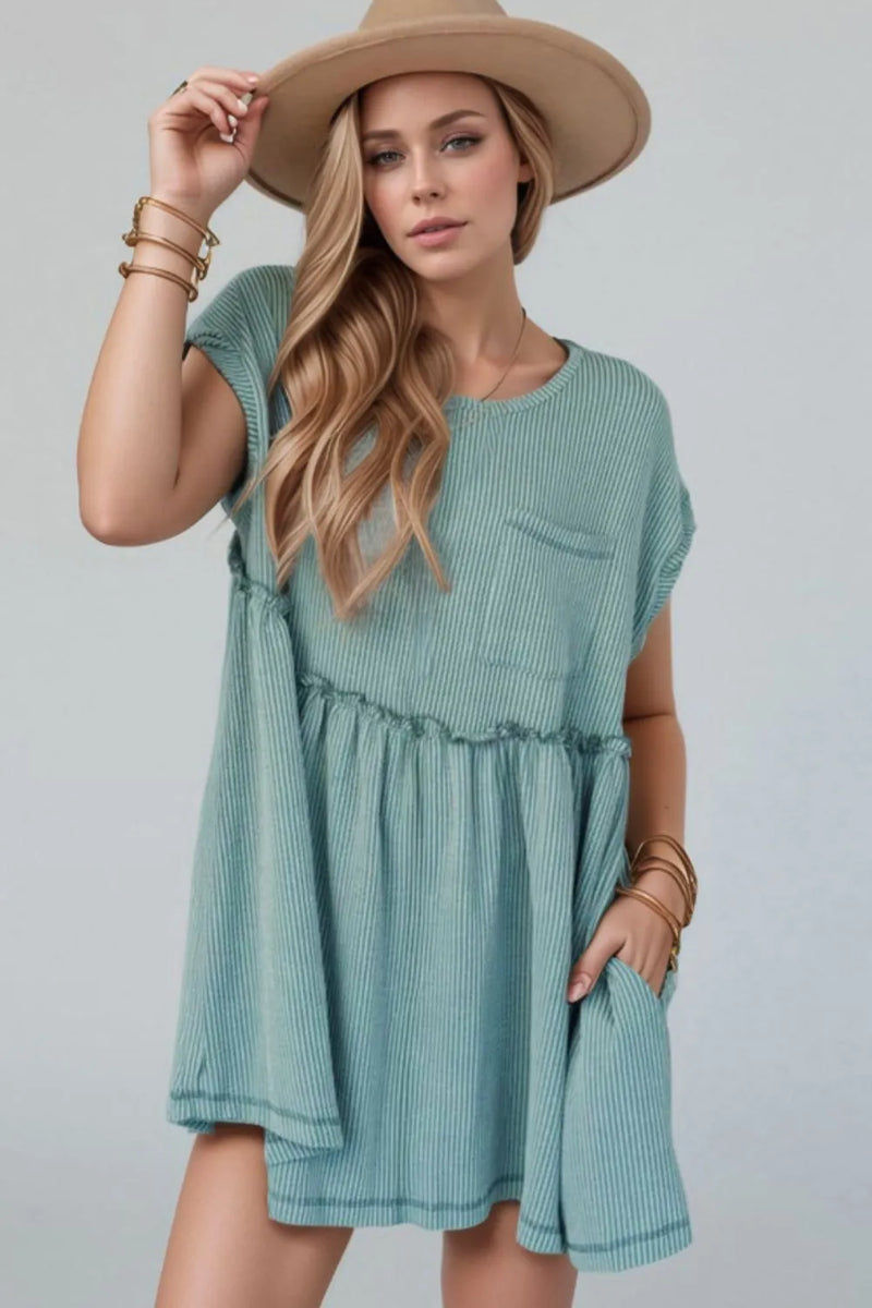 Almost a baby doll style mini dress with short sleeves, round neck, a line of frill separating the waist from the bodice and front shirt pocket on left side