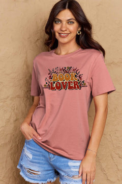 A pink t-shirt with 'Book Lover' printed in front of s mass of small flowers and stems