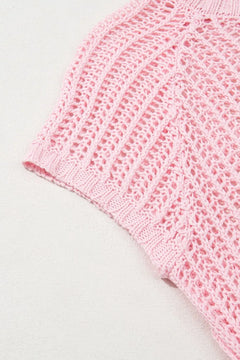Close-up of a pink crochet sleeve of a beach coverup on a light gray background
