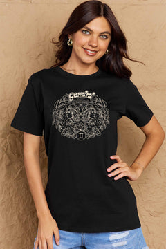 Black tshirt with round neck and short sleeves, design is all in pink with Gemini above two long haired twins facing away from each other and encircled by a wreath of flowers and leaves.At the bottom of the design is a circle with Roman numeral Two in it.