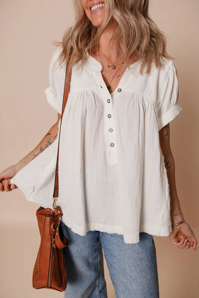 White cotton Textured Short Sleeve  Frayed Blouse. Collarless with five buttons down the front and made to hang full and loose