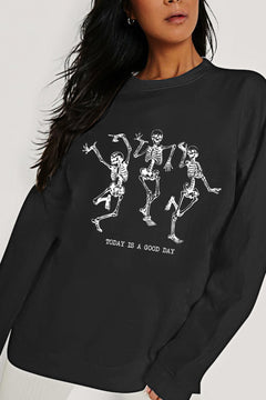 Black long sleeved sweatshirt with three dancing skeletons on the front with TODAY IS A GOOD DAY printed below.