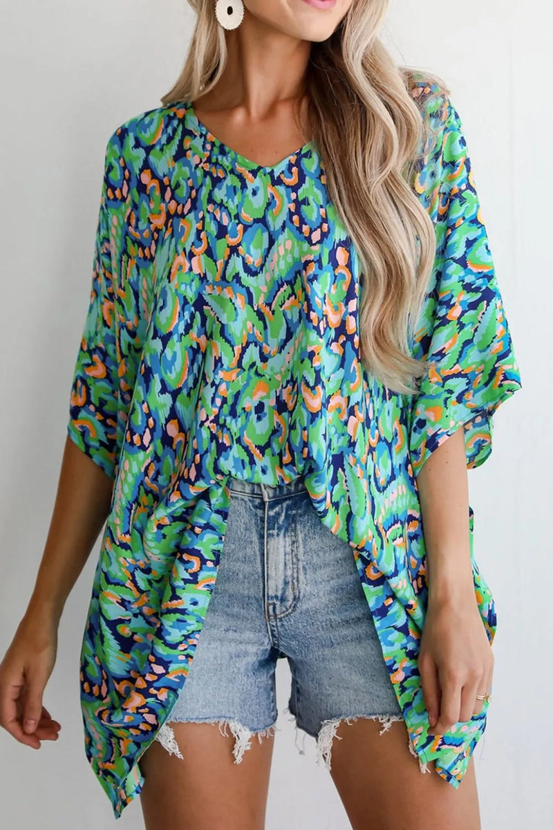 V neckd floral blouse with dropped shoulder and long body, 3/4 length loose sleeves worn here with front tucked into denim shorts
