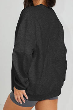 Person wearing a black sweatshirt with a plain background
