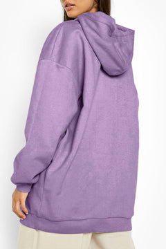 Person wearing a purple hoodie against a white background