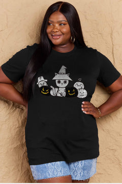 Woman wearing a black t-shirt with Halloween-themed design against a beige wall.