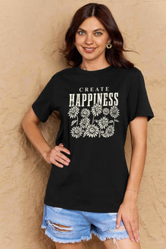 Black Tshirt with round neck and short sleeves, the caption in capital letters says CREATE HAPPINESS, with create being in small letters centered over Happiness. underneath the letters, in white as well, ten flowers arranged in three rows.