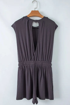 Purple sleeveless dress on a wooden hanger against a white background