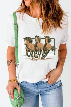 Person wearing a white t-shirt with horse graphic and holding a green purse.