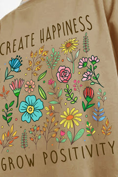 close up of Brown sweatshirt with floral design and text says CREATE HAPPINESS GROW POSITIVITY