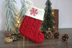 Red Christmas stockings style crew socks with snowflake, surrounded by festive decorations.