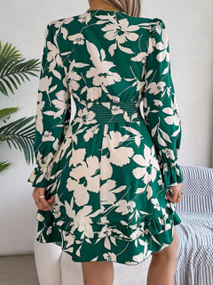 Green floral dress worn by a person with a white background