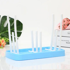 Pink blue baby dish drying rack on a white background