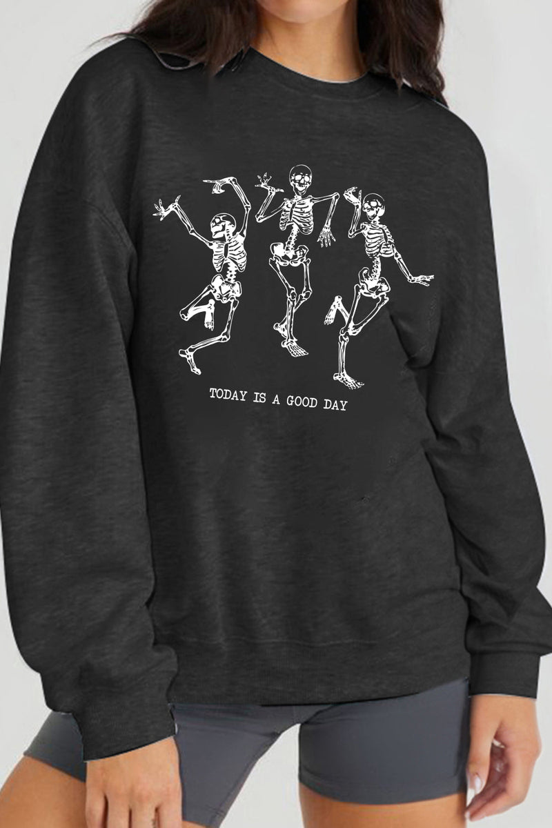 Black long sleeved sweatshirt with three dancing skeletons on the front with TODAY IS A GOOD DAY printed below.