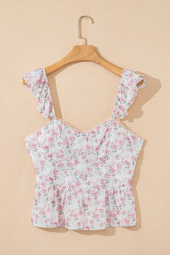 Floral top on a wooden hanger against a beige background