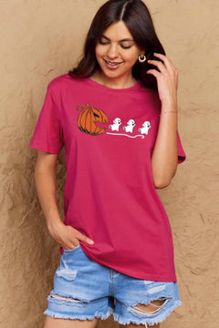 Pink Tshirt with Jackolantern appearing to be trying to eat a line of fleeing ghosts