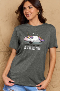 Grey Tshirt with a unicorn laying on it's belly with all legs splayed out and the slogan BEING AWESOME IS EXHAUSTING under it. Round neck and short sleeves