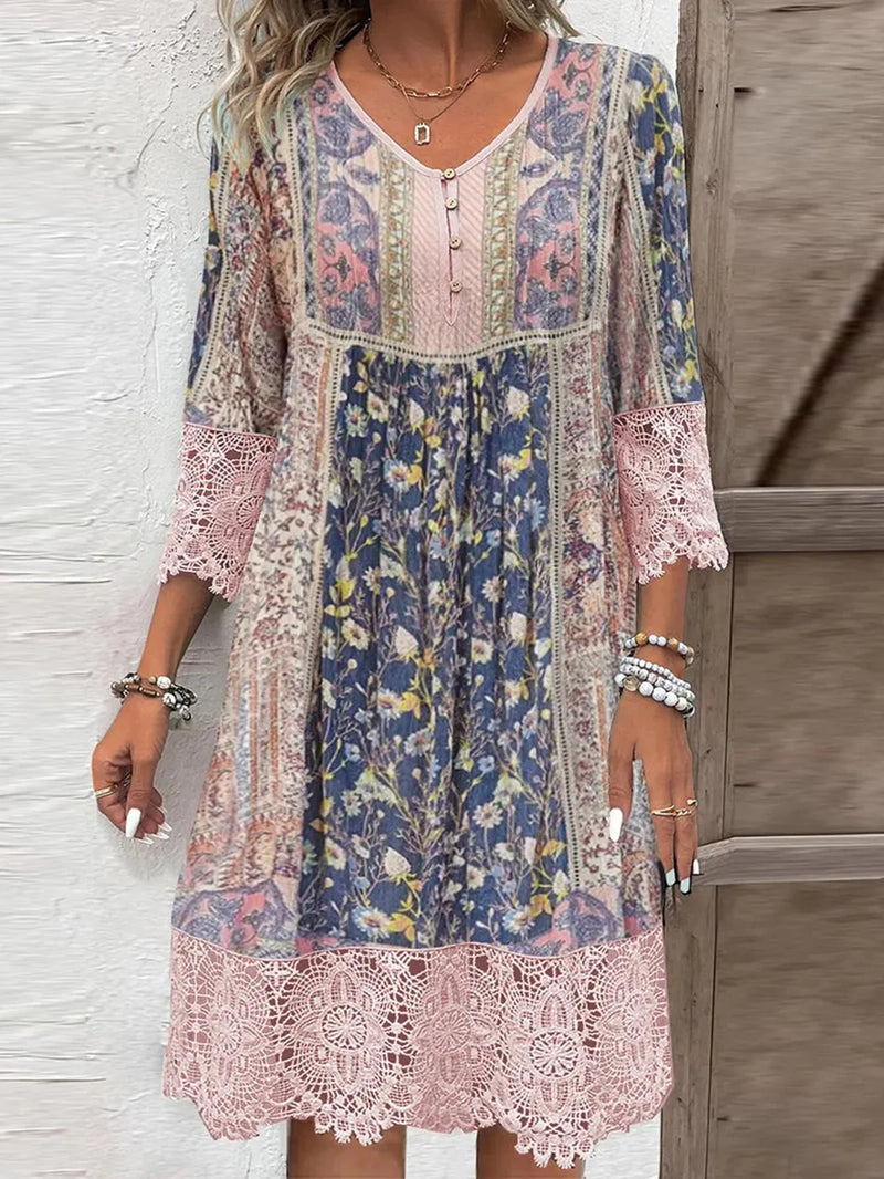 Lace 3/4 sleeve floral printed dress in patchwork type color blocks alternating with lace trim . Four small buttons on top