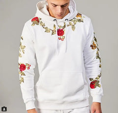 White hoodie with floral embroidery on a gray background