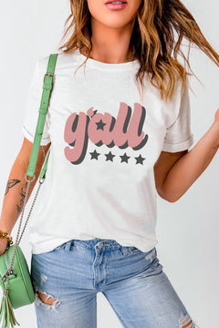 White round neck short cuffed sleeved tshirt with the caption y'all in cursive writting, lower case letters. The letters are colored pink, with grey shadows behind to make them look like they are 3d. Below are four grey stars in a row and the inside of the letter a is a matching grey star.