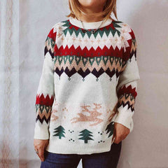 Person wearing a white patterned sweater with flying deer and Pine trees, other geometric designs against a neutral background