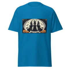 Blue t-shirt with Halloween-themed graphic of Three witches facing the full moon, brooms in had, stating GIrls Trip, Time to get Wicked