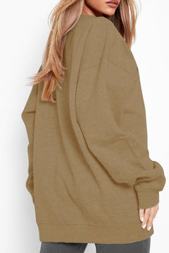 Person wearing a green oversized sweater against a white background