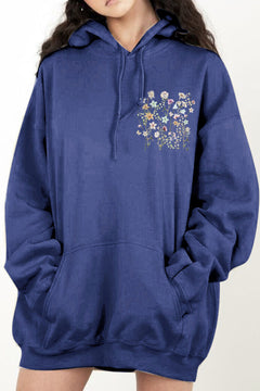 Blue hoodie with floral design on the chest pocket. Dropped shoulder and handwarmer pocket on front