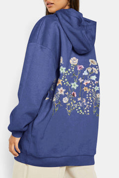Blue hoodie with floral design on the Back. Dropped shoulder and handwarmer pocket on front