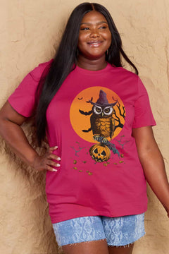 Woman wearing a pink t-shirt with a Halloween-themed design featuring an owl and pumpkin.