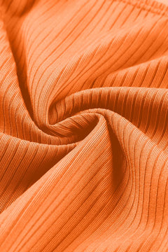 Close-up of orange fabric with a ribbed texture
