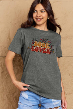 A grey t-shirt with 'Book Lover' printed in front of s mass of small flowers and stems