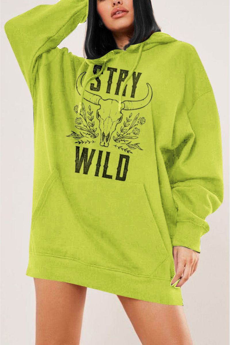 STAY WILD slogan in Big black letters on the front of this green pullover hoodie. In between the two words is a drawing of a long horned cow skull and some wild flowers around it. Dropped shoulders and hand warmer pocket, long body
