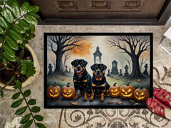Decorative doormat with Halloween design featuring two dogs and pumpkins on a doormat.